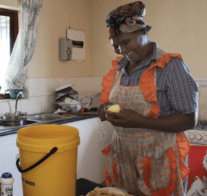 African Woman Smiles in the Kitchen